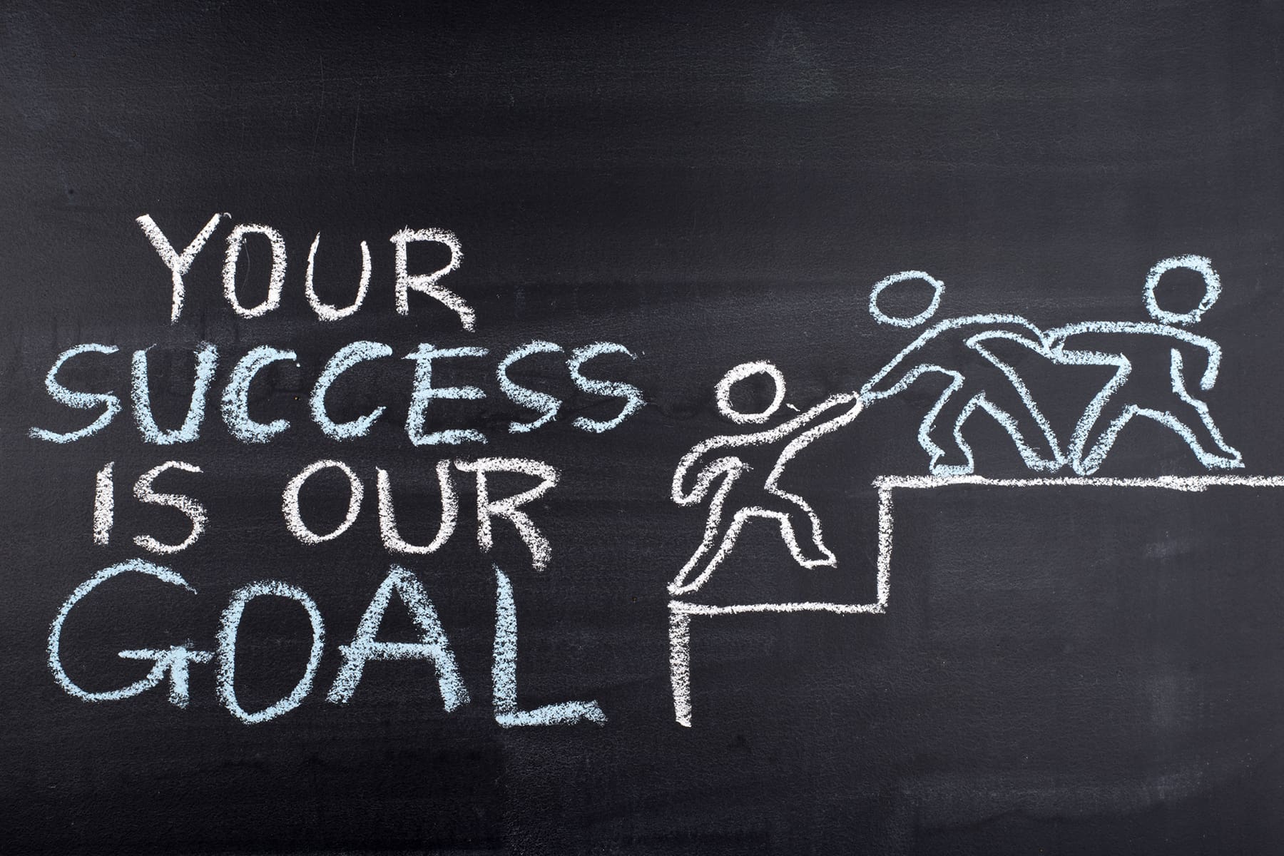 Your success is our goal hand drawing on blackboard
